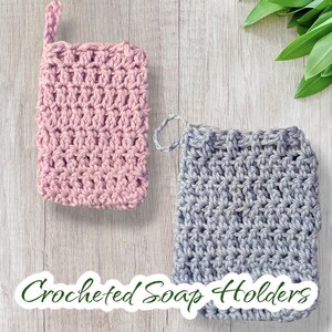 May include: Two crocheted soap holders, one pink and one gray, with a hanging loop. The soap holders are on a wooden surface with the text "Crocheted Soap Holders" below them.
