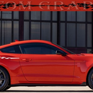 May include: A red sports car with black wheels and a white graphic design on the side. The car has a spoiler and the text "CUSTOM GRAPHICS" is at the top of the image.