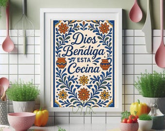 May include: A framed kitchen art print with the words "Dios Bendiga Esta Cocina" in navy blue script. The artwork features floral and pottery designs in orange, yellow, and blue. The print is displayed on a white countertop with kitchen utensils and plants.