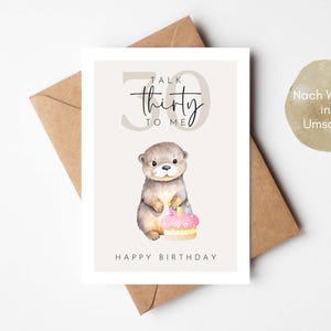 May include: A birthday card featuring a watercolor illustration of an otter holding a cake. The card has the text "Talk Thirty to Me" and "Happy Birthday". The card is on a brown envelope.