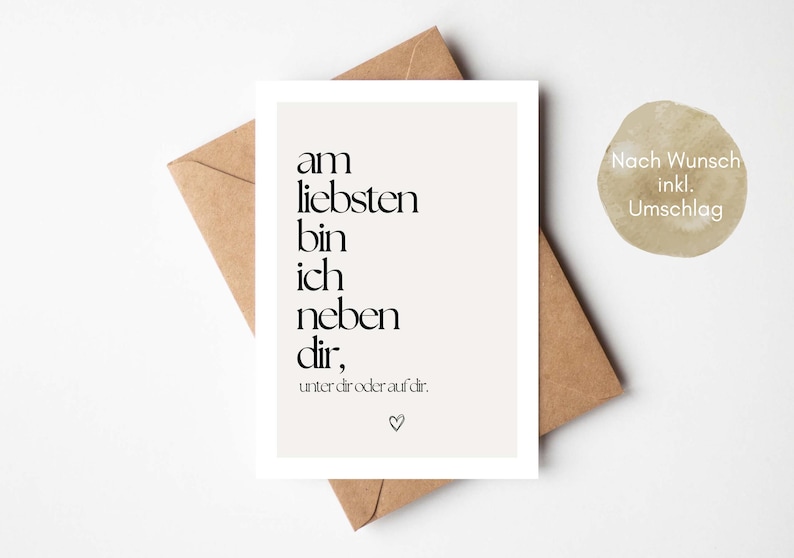 May include: A greeting card with the text "am liebsten bin ich neben dir, unter dir oder auf dir." in black font on a white background. The card is placed on a brown envelope. A small, round sticker with text is also visible.