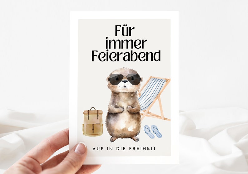 May include: A card with a cartoon otter wearing sunglasses and a backpack. The text on the card reads "F&uuml;r immer Feierabend" and "AUF IN DIE FREIHEIT".