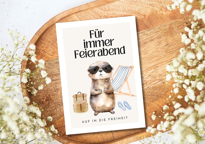 May include: A card with a cartoon otter wearing sunglasses and a backpack. The text on the card reads "F&uuml;r immer Feierabend" and "AUF IN DIE FREIHEIT".