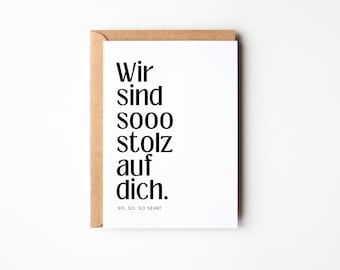 May include: A white card with black text that reads "Wir sind sooo stolz auf dich. So, so, so sehr!" The card is in a brown envelope.