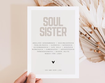 May include: A white card with a light brown background and black text. The text reads "Soul Sister" in large letters and then lists a series of qualities, such as "absolute heart person", "secret keeper", "problem solver", "listener", "advisor", "crisis manager", "good soul", "counselor", "encourager", "confidant", "supporter", "tear dryer", "better half", and "person for life". The card also has a small black heart and the text "I love you" in black.