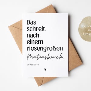 May include: A white card with black text that reads "Das schreit nach einem riesengro&szlig;en Mutausbruch. OH YES, DO IT!"  The card is sitting on a brown envelope. The text "Nach Wunsch inkl. Umschlag" is written on the envelope.