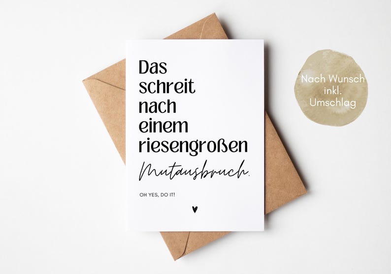 May include: A white card with black text that reads "Das schreit nach einem riesengro&szlig;en Mutausbruch. OH YES, DO IT!"  The card is sitting on a brown envelope. The text "Nach Wunsch inkl. Umschlag" is written on the envelope.