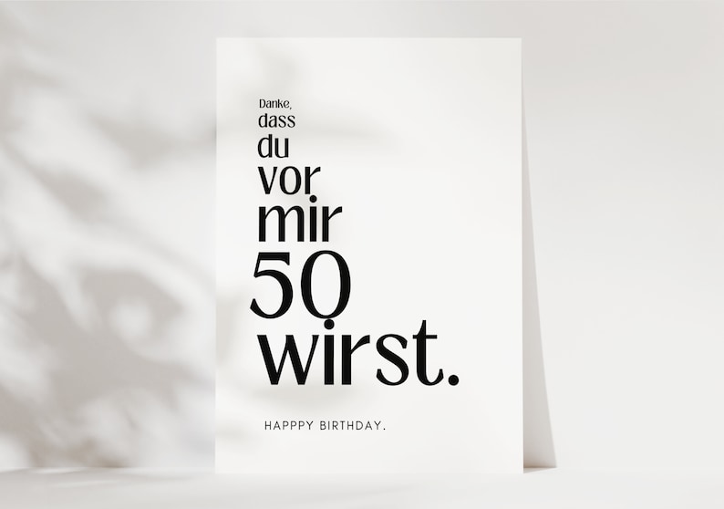May include: A white card with black text that reads "Danke, dass du vor mir 50 wirst." and "HAPPY BIRTHDAY."