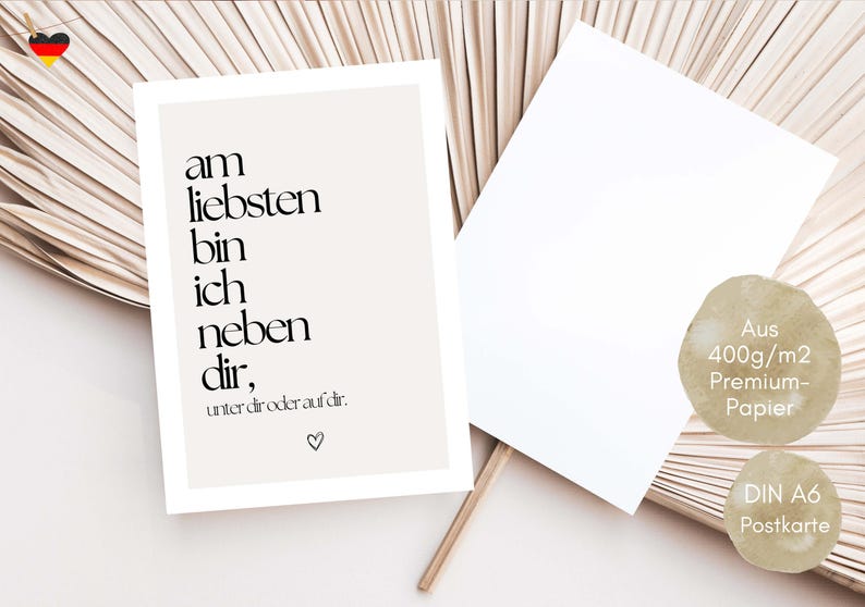 May include: A beige postcard with black text that reads "am liebsten bin ich neben dir, unter dir oder auf dir." A blank white postcard is next to it. The postcard is made of 400g/m2 premium paper and is a DIN A6 postcard.