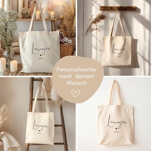 May include: Off-white canvas tote bags with the word "Lawyer" in black script, personalized with a name below. The bags have long handles and are displayed in various settings, including hanging on a wooden rack.