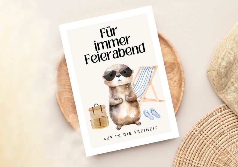 May include: A card with a watercolor illustration of an otter wearing sunglasses and a backpack. The text on the card reads "F&uuml;r immer Feierabend" and "Auf in die Freiheit".