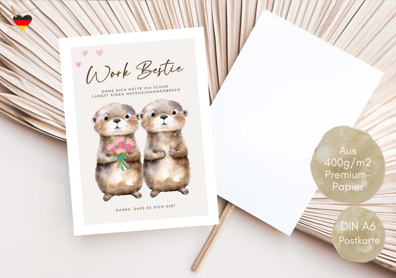 May include: A greeting card with the text "Work Bestie" and two otter illustrations. One otter holds a bouquet of pink flowers. The card is accompanied by a blank white card and two informational stickers.