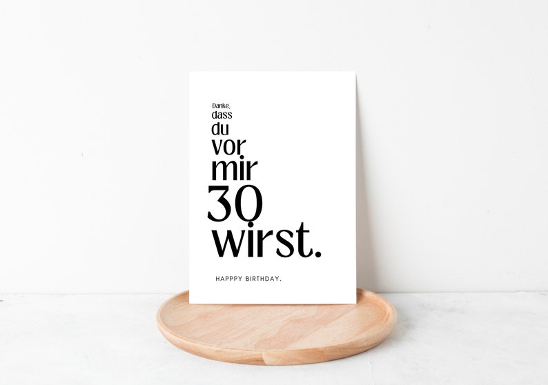 May include: A white card with black text that reads "Danke, dass du vor mir 30 wirst. Happy Birthday."