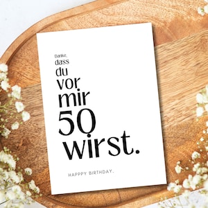 May include: A white card with black text that reads "Danke, dass du vor mir 50 wirst." and "HAPPY BIRTHDAY."