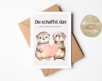 May include: A greeting card featuring two otters holding a pink heart. The card reads "Du schaffst das...weil du einfach krass bist!" and "Nach Wunsch inkl. Umschlag".