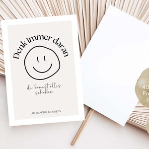 May include: A beige postcard with the text "Denk immer daran" and a smiley face. The postcard also includes the text "da kannst alles schaffen" and "ALLES WIRKLICH ALLES". A blank white postcard is next to it.