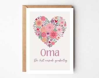 May include: A greeting card with a floral heart design in shades of pink, peach, and green. The word "Oma" is written in a mauve color, with the phrase "Du bist einfach großartig" below it. The card is in a brown envelope.