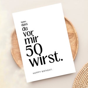 May include: A white card with black text that reads "Danke, dass du vor mir 50 wirst. Happy Birthday."