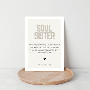 May include: A beige printable poster with the text "SOUL SISTER" in large letters. The text below describes a soul sister as a "true friend" with a list of qualities. The poster has a small black heart at the bottom and the text "I love you" in German.