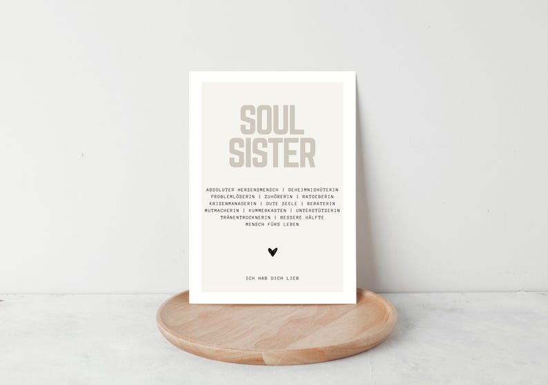May include: A beige printable poster with the text "SOUL SISTER" in large letters. The text below describes a soul sister as a "true friend" with a list of qualities. The poster has a small black heart at the bottom and the text "I love you" in German.