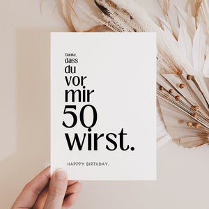 May include: A white card with black text that reads "Danke, dass du vor mir 50 wirst."  Happy Birthday.