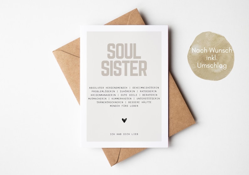 May include: A light brown card with the text "SOUL SISTER" in large, bold, gray letters. The card has a light gray background and includes a list of qualities that describe a soul sister. The text "ICH HAB DICH LIEB" is at the bottom of the card.