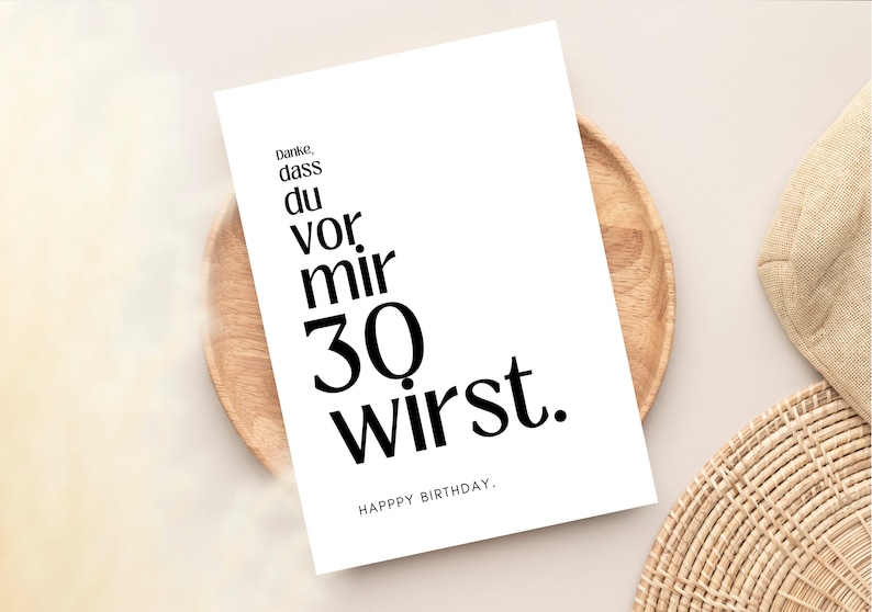 May include: A white card with black text that reads "Danke, dass du vor mir 30 wirst. Happy Birthday."