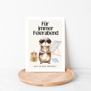 May include: A card with a cartoon otter wearing sunglasses and a backpack. The text on the card reads "F&uuml;r immer Feierabend" and "AUF IN DIE FREIHEIT".