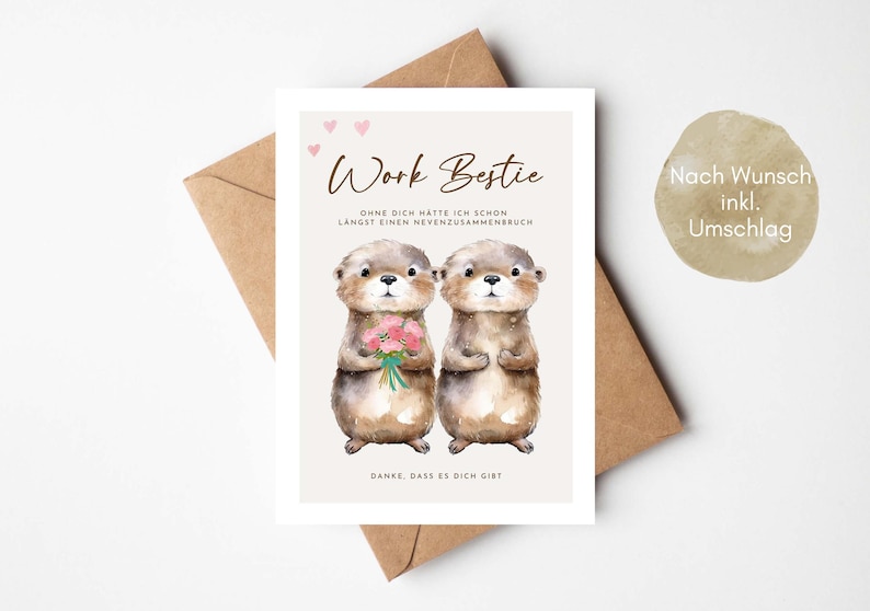 May include: A greeting card with two watercolor otters, one holding flowers. The card reads "Work Bestie" with German text below. A brown envelope is behind the card. A round sticker with German text is on the right.