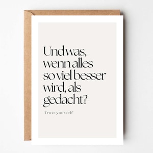 May include: A minimalist art print with the German text "Und was, wenn alles so viel besser wird, als gedacht?" and the English translation "Trust yourself." The print is on a cream background, framed in white, and set in a brown envelope.