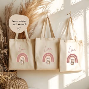 Hej.Otti® Sac en jute personnalisé pour enfants avec motif arc-en-ciel et loutre – sac en tissu avec nom pour cadeau de crèche ou d'école