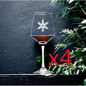 May include: A set of four clear glass wine glasses, each featuring a white etched six-pointed star design on the bowl. The glasses are filled with a dark red liquid and are displayed together, with the red text x4 visible in the image.