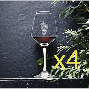 May include: Set of four clear glass wine glasses with a skull design etched on the front. The glasses are filled with red wine. The text "x4" is in yellow in the lower right corner of the image.