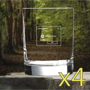 May include: Set of four clear glass tumblers with a silver band around the bottom. The tumblers are empty and appear to be on a wooden surface. The text "x4" is in yellow in the bottom right corner of the image.