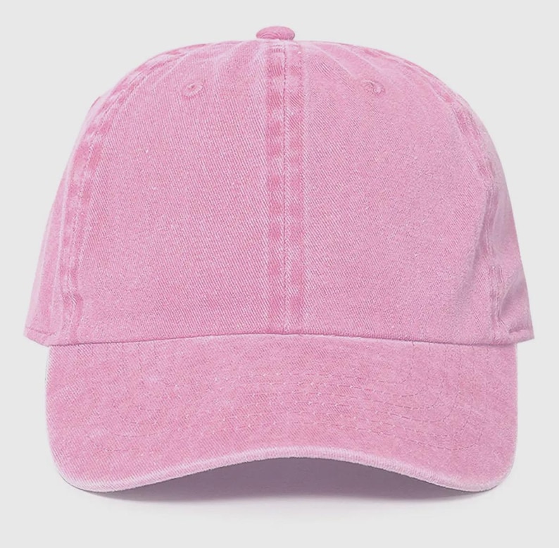 May include: A pink, cotton baseball cap with a slightly distressed look.