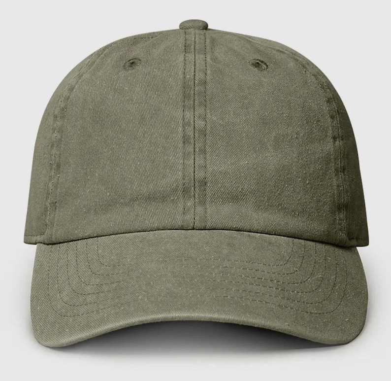 May include: A plain, olive green baseball cap with a curved brim.
