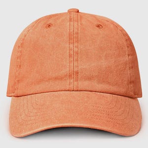 May include: A solid orange baseball cap with a slightly distressed look. The cap has a curved brim and a traditional six-panel design.