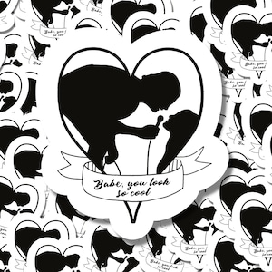 May include: Black and white sticker featuring a silhouette of a couple singing into a microphone within a heart shape. The text "Babe, you look so cool" is on a banner below the heart. The stickers are scattered across a white background.