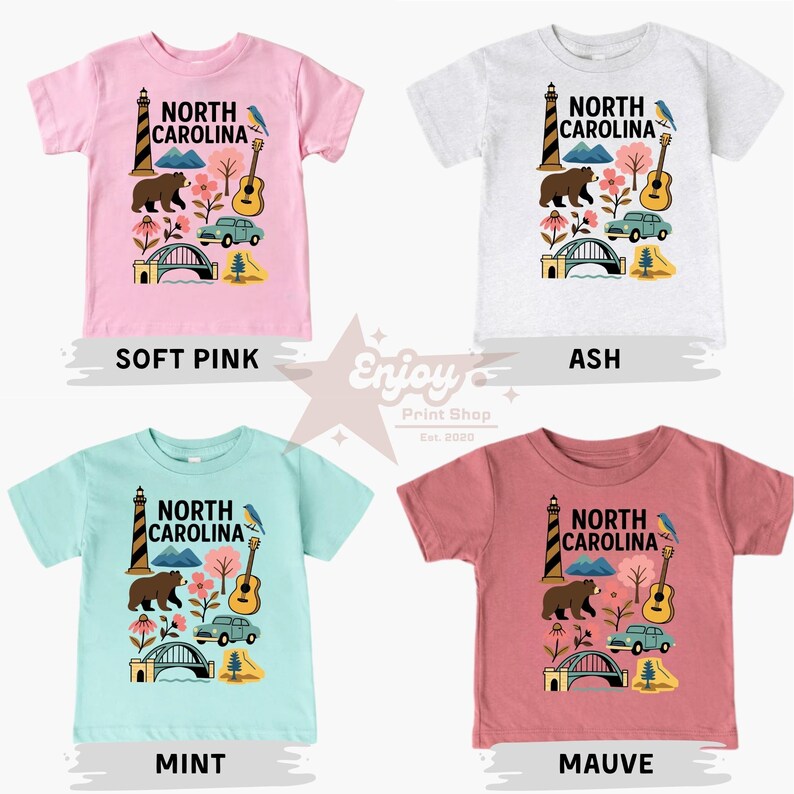 May include: Four short-sleeved t-shirts in soft pink, ash, mint, and mauve. Each shirt features a North Carolina design with a lighthouse, bear, guitar, car, bridge, and flowers. The shirts are labeled with their color.