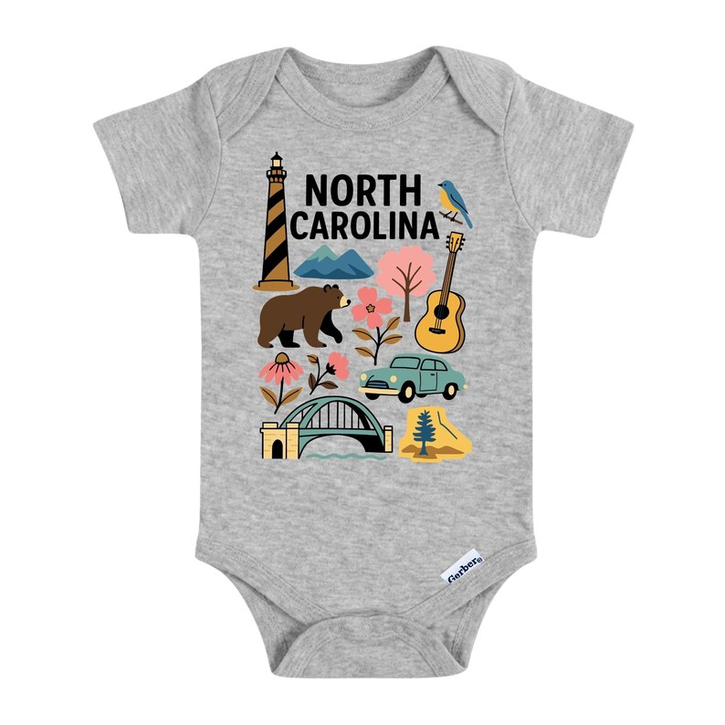 May include: A gray baby onesie with a colorful graphic featuring a lighthouse, mountains, a bear, flowers, a guitar, a car, a bridge, and a pine tree. The text "NORTH CAROLINA" is printed at the top.