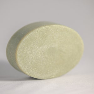 May include: A light green oval-shaped bar of soap.