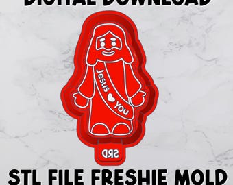 May include: A red plastic cookie cutter mold featuring a stylized figure of Jesus with a sash that reads Jesus heart you. The mold includes a bottom tab with the text SRD. The text DIGITAL DOWNLOAD and STL FILE FRESHIE MOLD HOUSING WITH TAB are present.