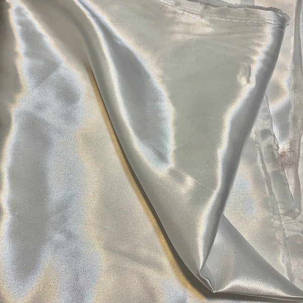 Charmeuse satin sell by yard color white width 58 inches. Soft satin fabric 100% polyester Lustrous , smooth and shiny fabric,