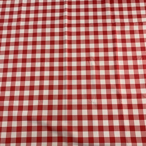 May include: Red and white checkered fabric with a subtle fold in the center.