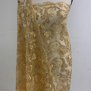3-yard Gold-colored lace fabric design named Angela, sequins and intricate embroidery with double scalloped edges. Width 49/50&quot;