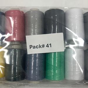 Peut inclure: Un paquet de 10 bobines de fil de différentes couleurs, dont jaune, rouge, gris, noir, blanc, vert et bleu. Le paquet est étiqueté "Pack# 41".