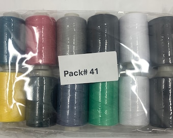 Puede incluir: Un paquete de 10 carretes de hilo de varios colores, incluyendo amarillo, rojo, gris, negro, blanco, verde y azul. El paquete está etiquetado como "Pack# 41".