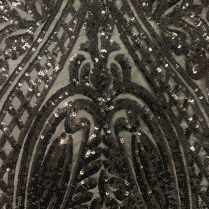 Black All over Sequins fabric color black width 55 inches, fabric has 3 inch salvage (plain mesh) on each side. free sample.