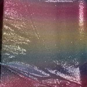 May include: A rainbow sequined fabric with a gradient of colors, starting with a light blue at the bottom and transitioning to a deep pink at the top.