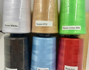 May include: Six spools of thread in various colors, including snow white, taupe, neon lime, brown, blue, and red. Each spool has a label with the color name and a number.